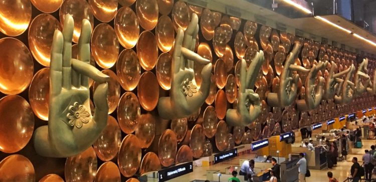 Metal mural of hands at the Delhi airport